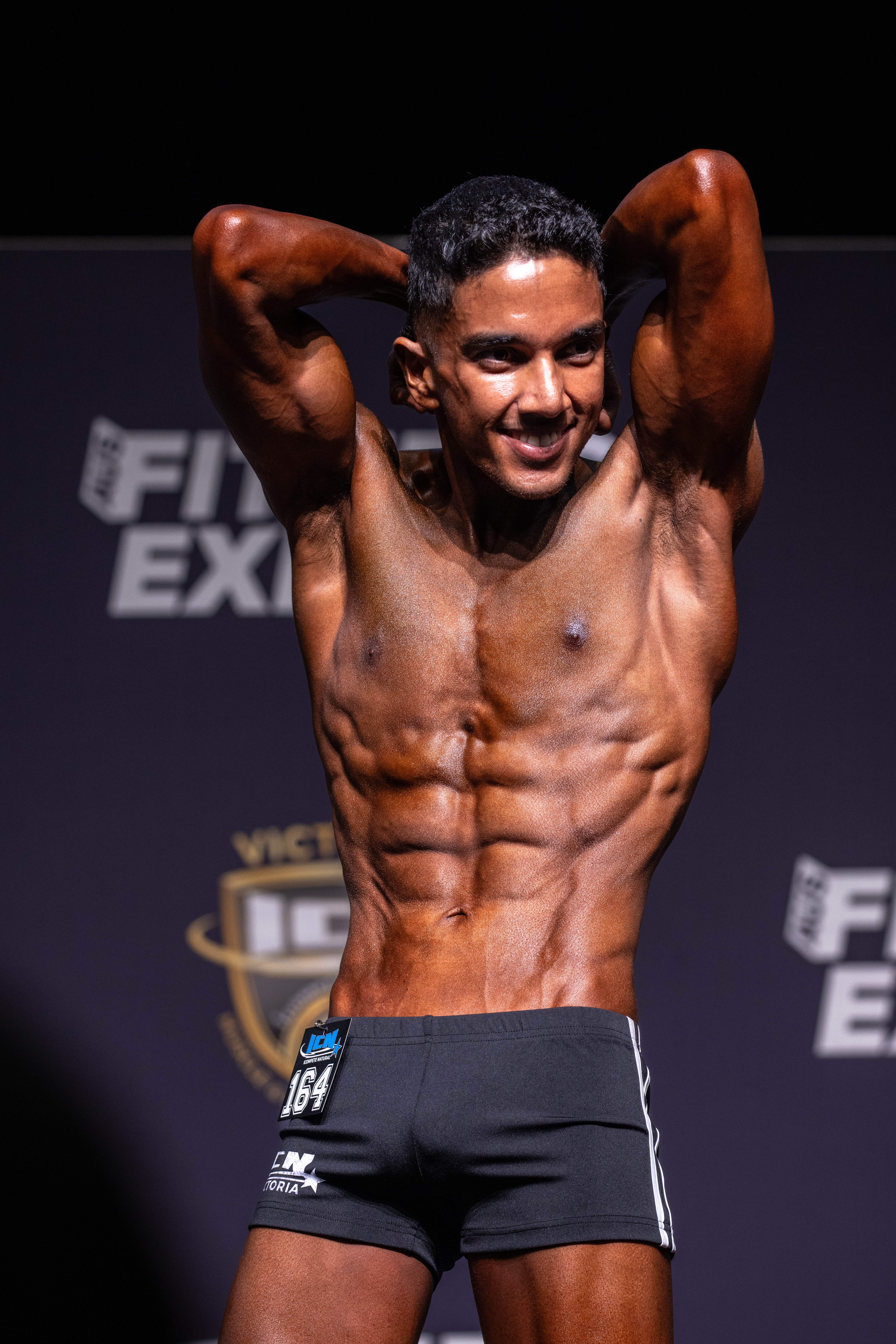 Front stage pose showing peak conditioning and symmetry