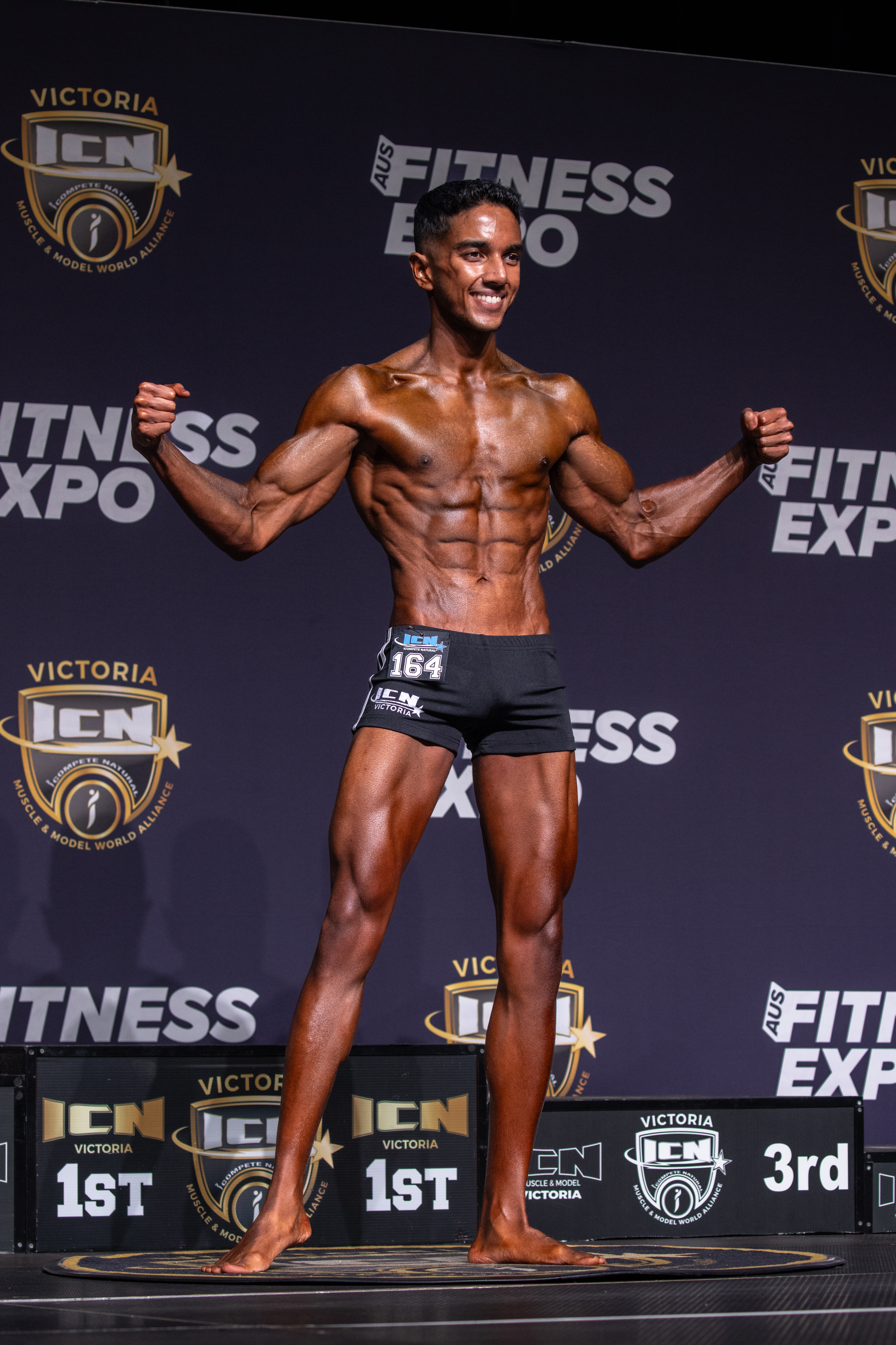 Back stage photo showing posterior chain conditioning and symmetry